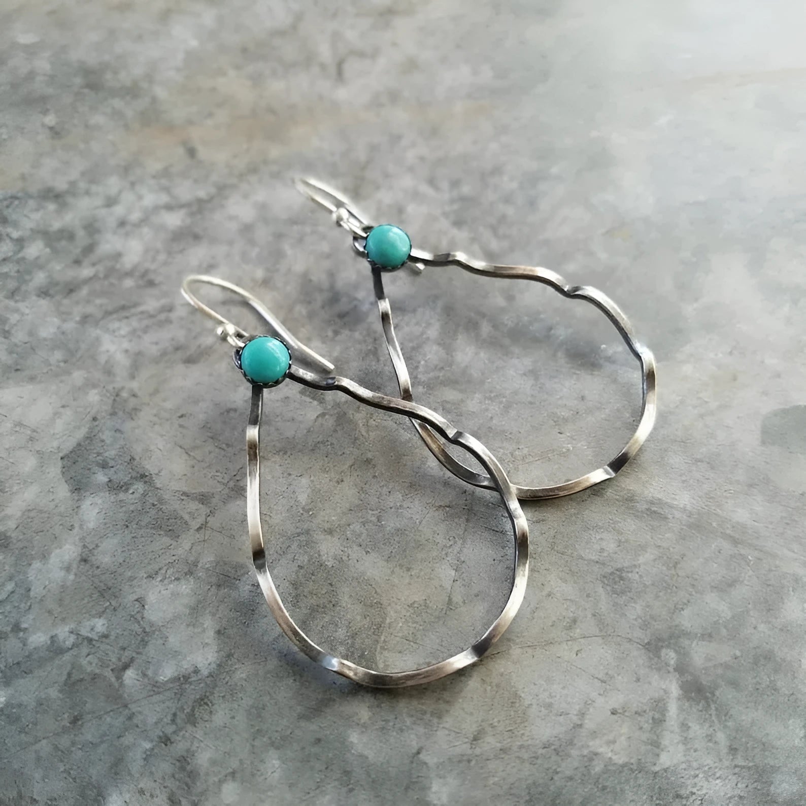 A pair of vintage-style bohemian circle earrings in antique silver alloy with turquoise colour accents.