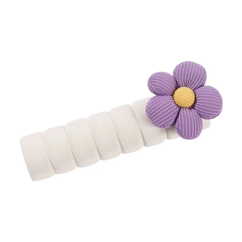 Flower pattern soft PEVA door handle protective cover on a round door knob.