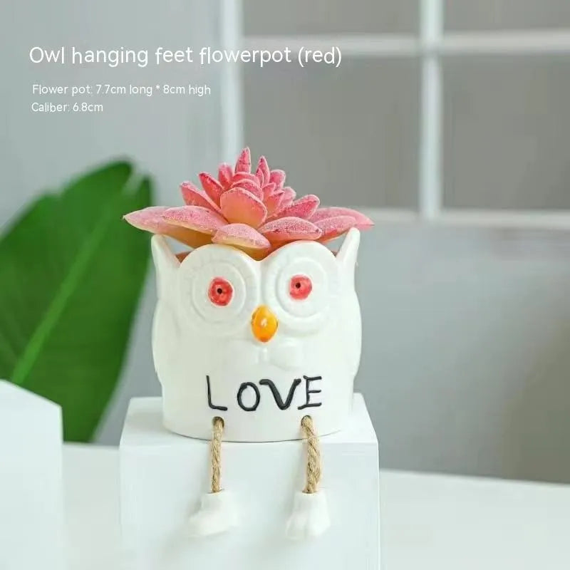 Ceramic cartoon-style succulent flowerpot with hanging foot design on desktop