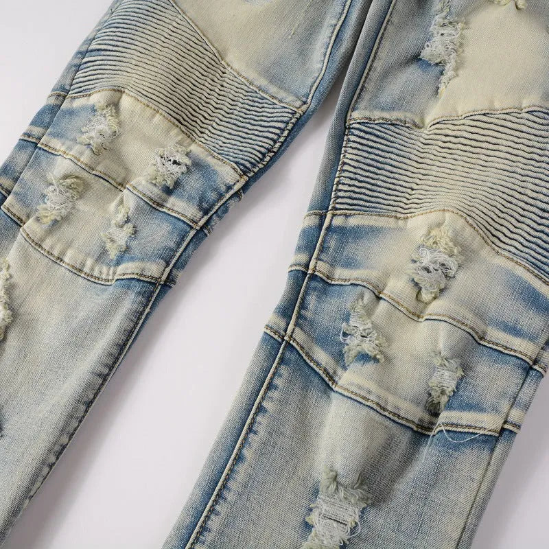 Light blue men's slim fit distressed jeans with hand-frayed details and a straight leg cut.