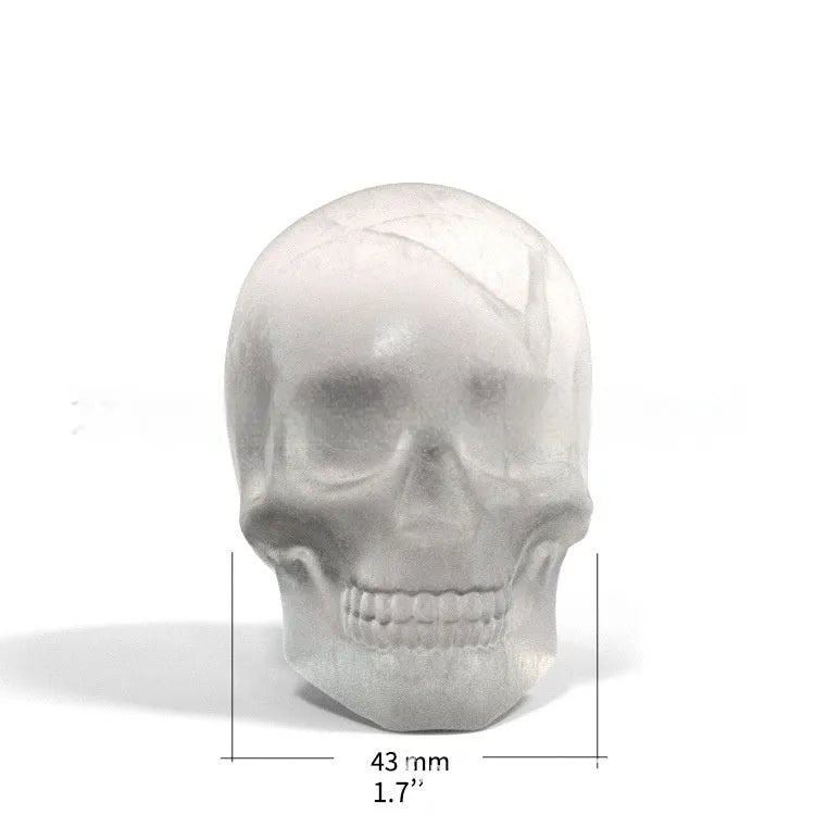 3D Halloween skull-shaped silicone ice cube tray on a table.