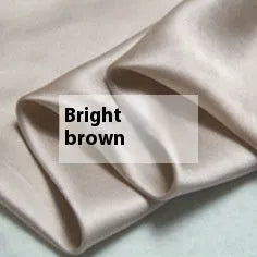 Double-sided solid colour silk duvet cover shown in Lotus Pink on a bed