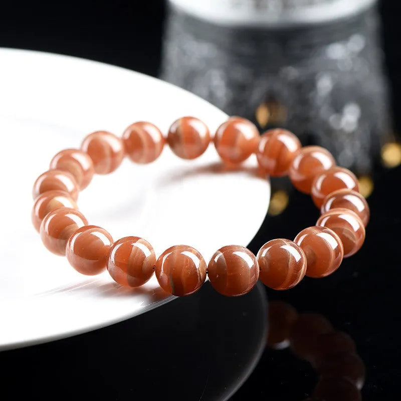 Natural old mine rhodochrosite round bead bracelet with ruyi elements, available in 6mm or 8mm bead sizes.
