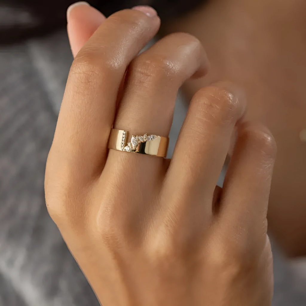 Gold-coloured electroplated copper band ring for women shown on a finger.