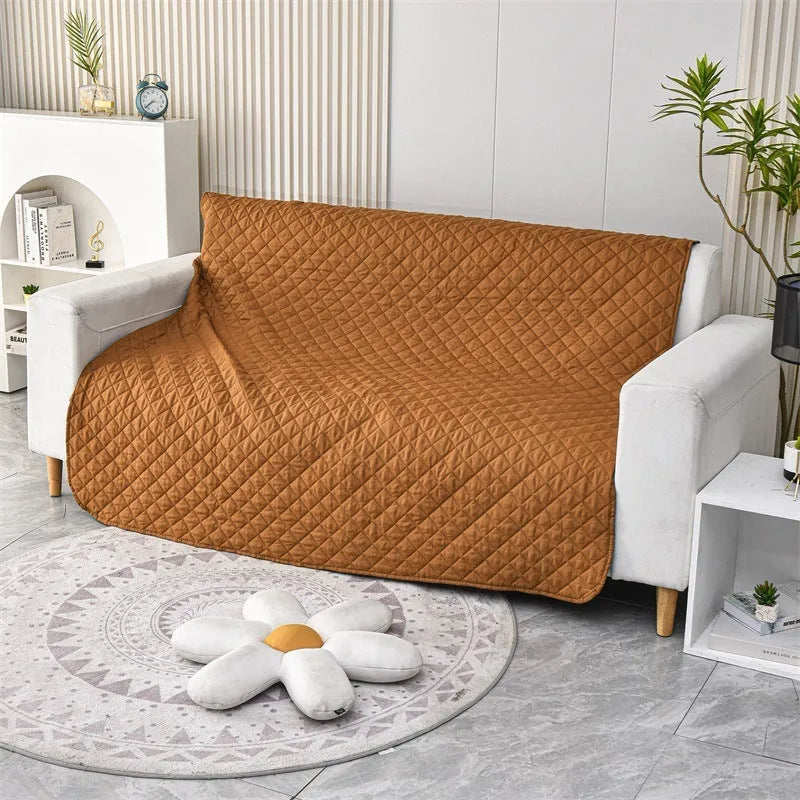 Reversible waterproof dog blanket on sofa showing two colour options with multiple size measurements