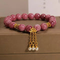 Natural stone bracelet with lotus tassel design, pearl pendant, and electroplated pink finish
