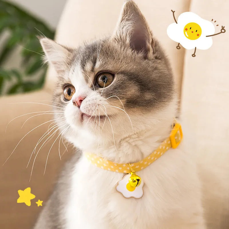 Green adjustable cat collar with a silver bell and a matching bow tie on a white background