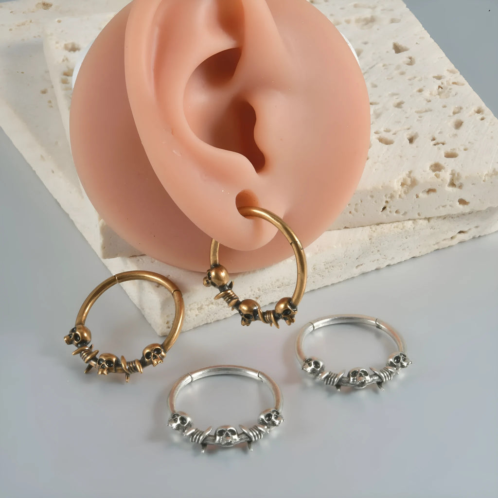 Copper punk earrings with embossed ghost head designs in antique gold and silver finishes