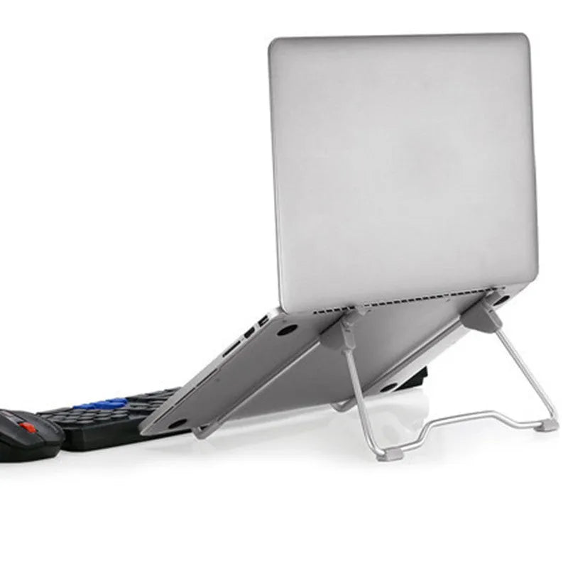 Grey aluminium alloy and engineering plastic stand holding a mobile phone and a laptop on a desk.