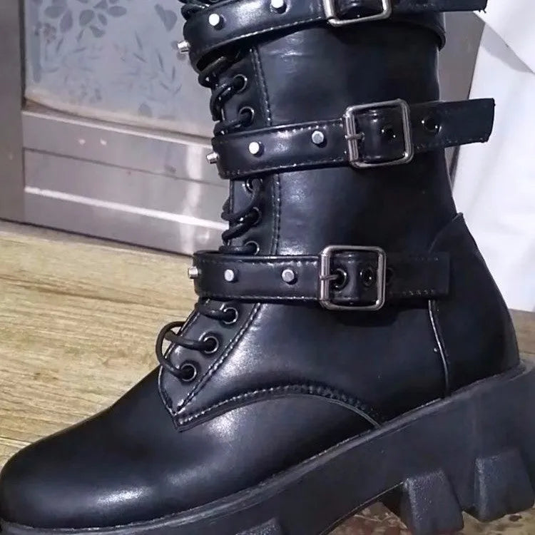 Women's black mid-calf knight boots with metal buckle and side zipper on a round toe.