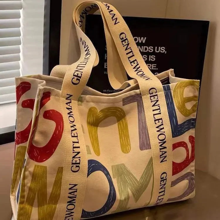 Large canvas tote bag with printing detail in black letters, coloured letters, or pattern style variations