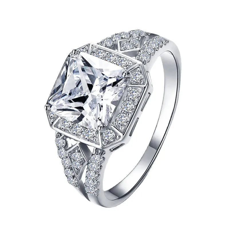 Platinum-colour zircon ring with hollow geometric quadrilateral design on a copper base