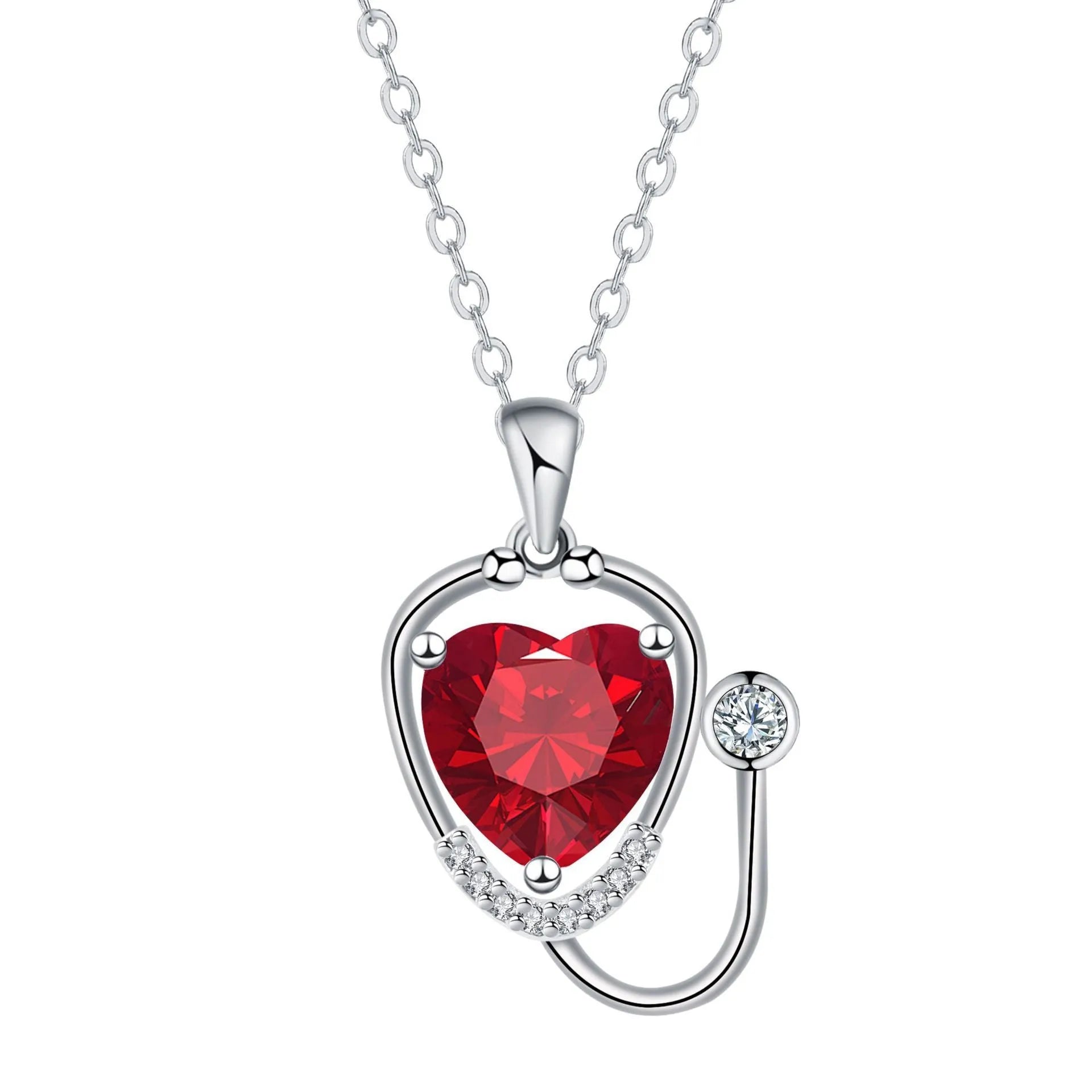 Close-up of a red diamond coloured stethoscope pendant necklace with cross, heart and wing details on a copper chain.
