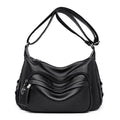 Large black women's shoulder bag with multiple internal organisation pockets and crossbody strap