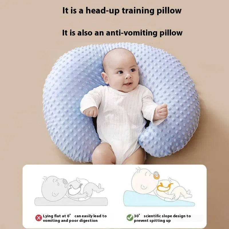 Grey nursing pillow with milk spill prevention feature for breastfeeding support