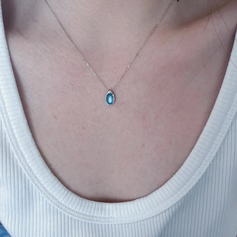 Navy blue water drop necklace with geometric pendant on cross chain, adjustable length jewellery