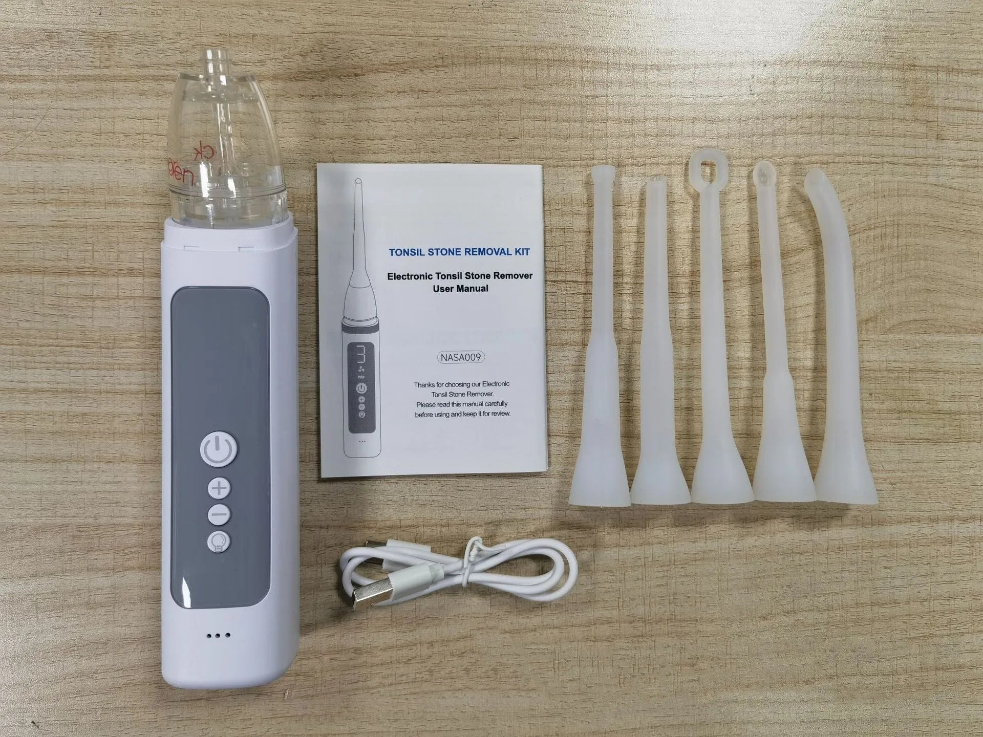 Milky white tonsil stone removal tool with curved extraction tip for oral hygiene and dental stone management