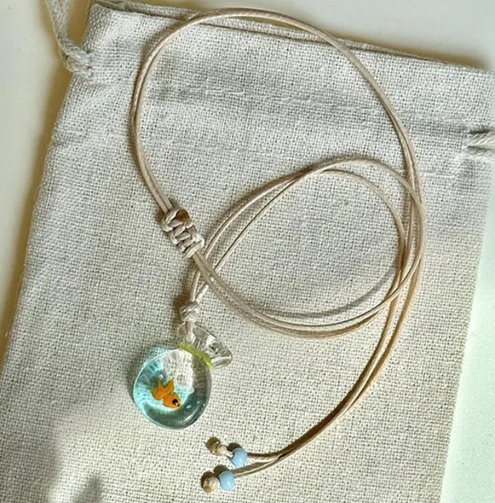Women's joker design pendant necklace with coloured glaze charm on a cotton and linen clavicle chain.