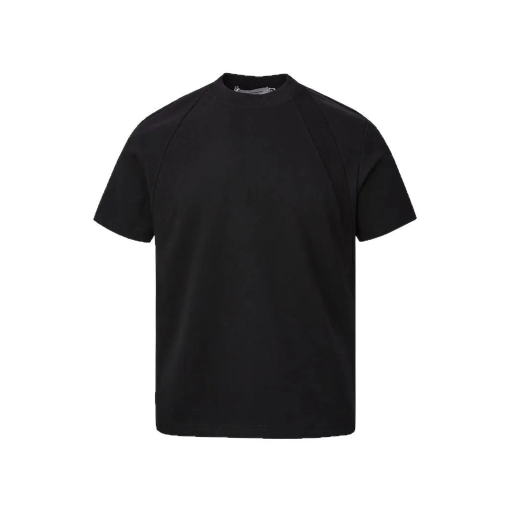 Man wearing a loose-fit black short-sleeve polyester top with air layer stitching.