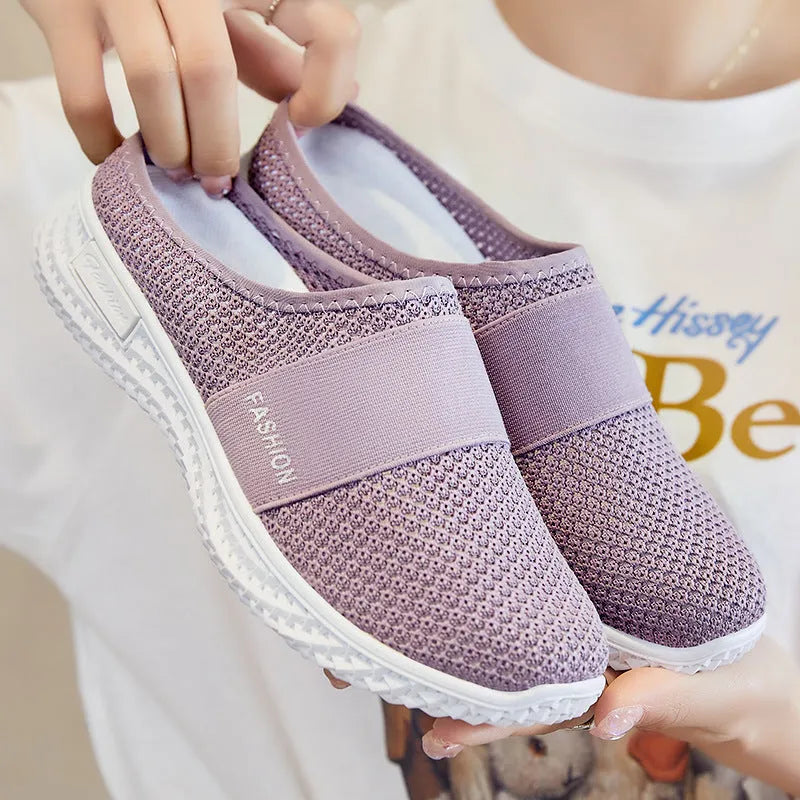 Women's flat casual shoes in mesh fabric with hollow-out design on a round toe.