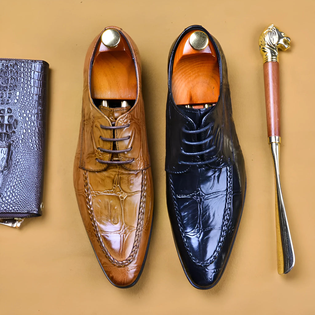 Men's black alligator pattern leather shoes with a silver horse bit buckle on the front.