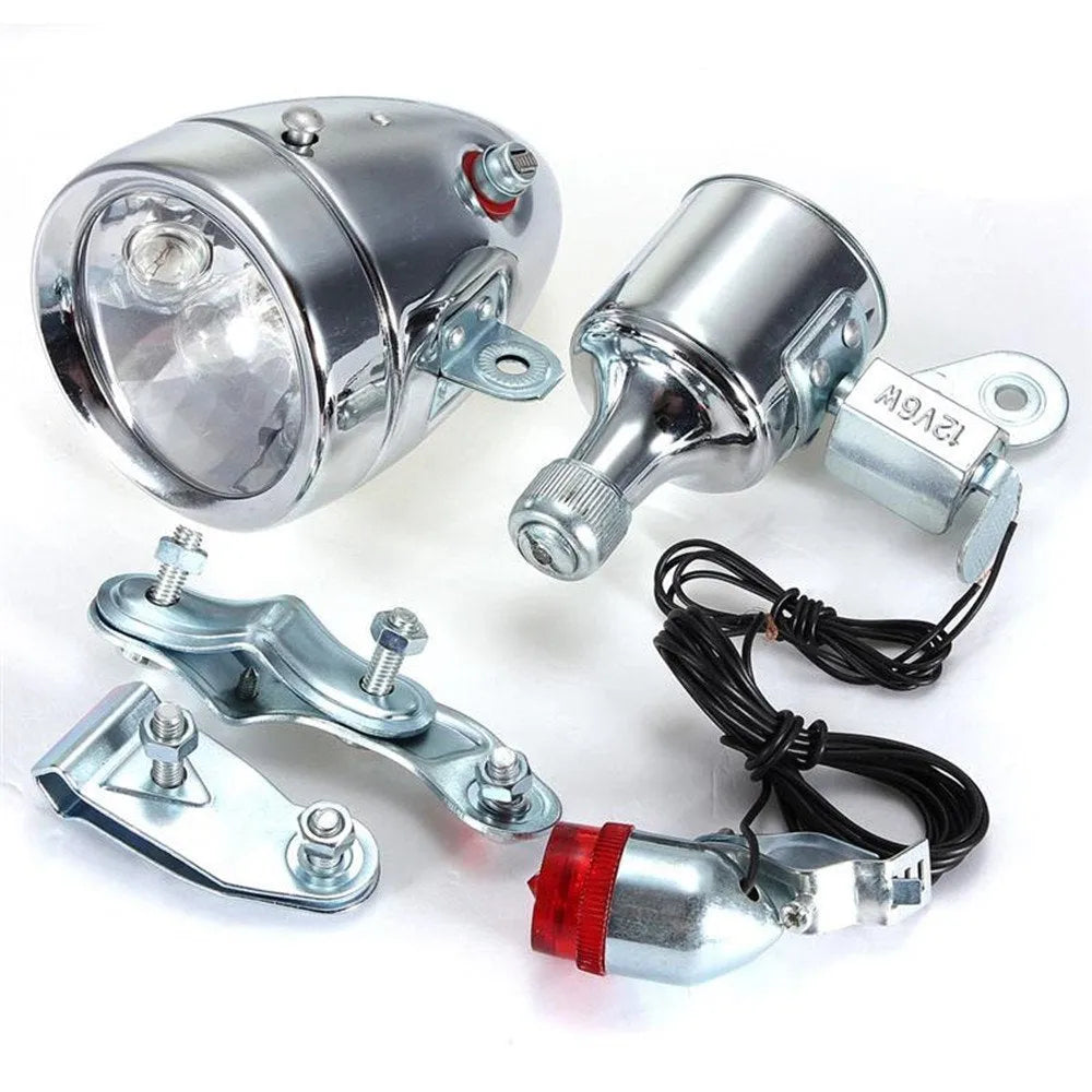 Silver bicycle dynamo light kit with generator head for friction drive mounting on bicycle frame