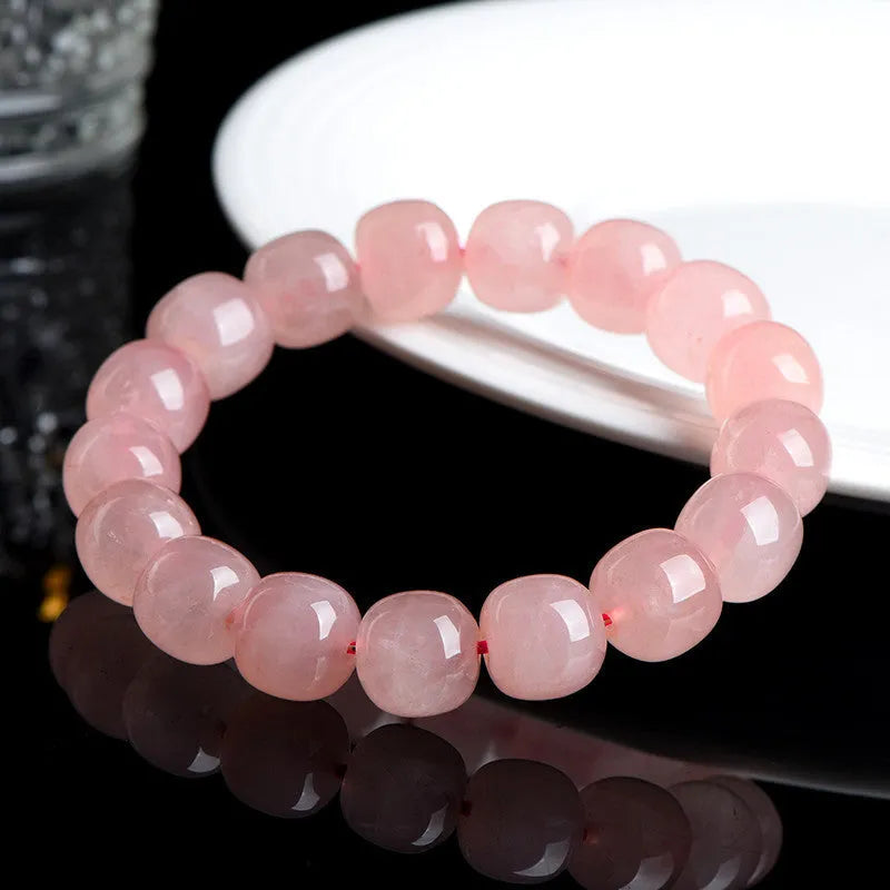 Natural pink crystal bead bracelet with geometric barrel-shaped design measuring 8-10mm per bead