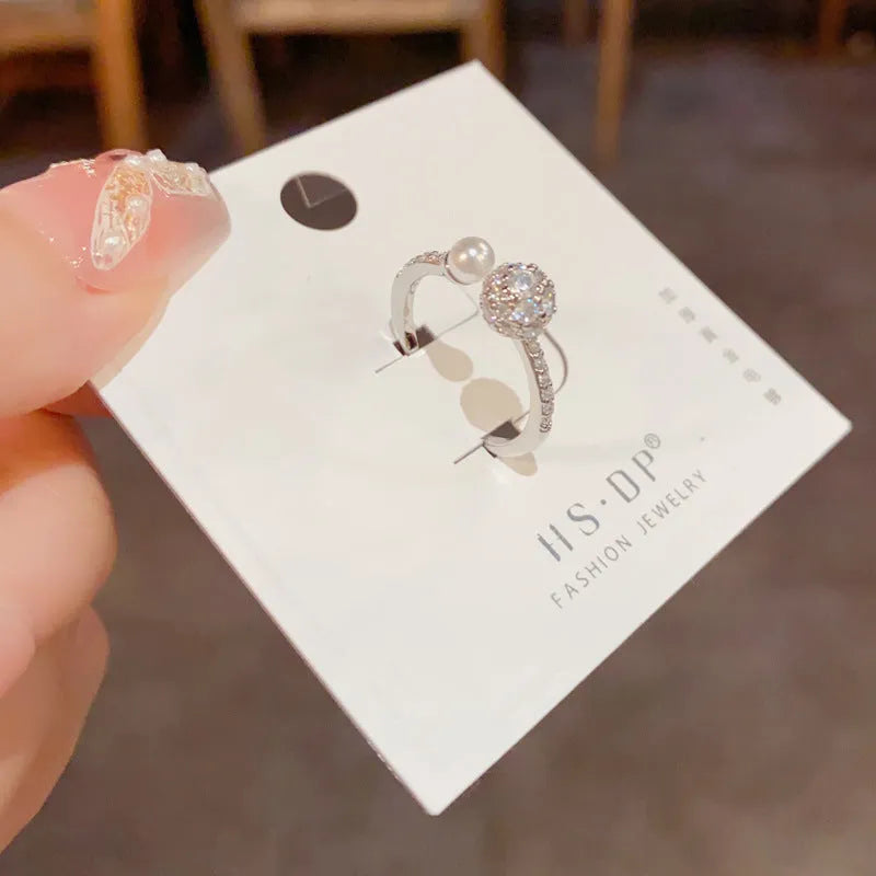 Open-end pearl ring with round zircon decoration in gold or silver colour with thick real gold plating