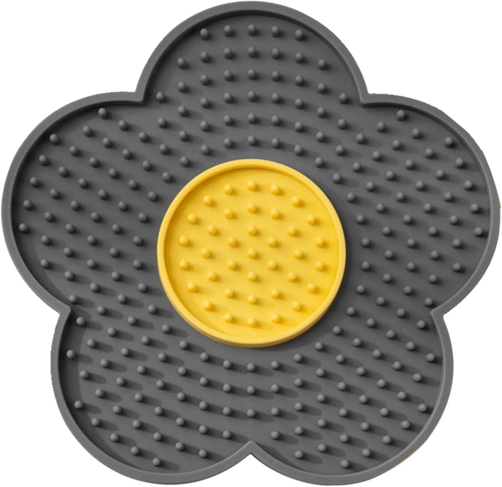 Flower-shaped blue silicone pet lick mat with suction cups on a smooth surface