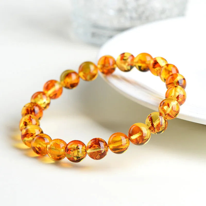 Natural yellow piebald amber bracelet with polished geometric beads on a string