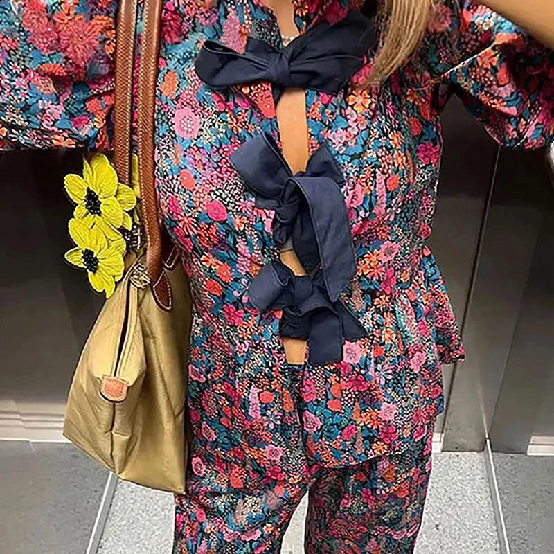 Floral printed two-piece trouser suit with puff sleeves and tie-neck detail in picture colour