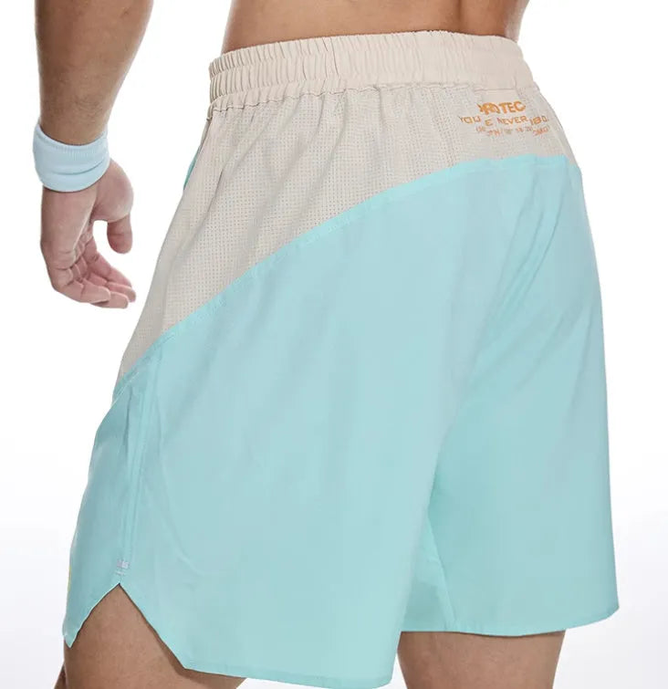 Men's loose dark grey workout shorts with a white lace-up fly front on a neutral background.