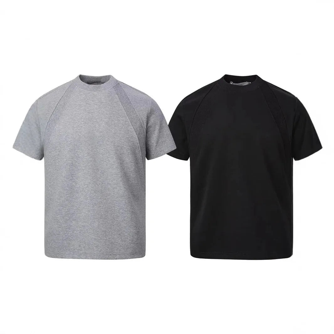 Man wearing a loose-fit black short-sleeve polyester top with air layer stitching.