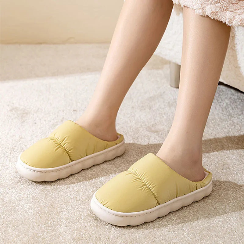 A pair of down cotton slippers with an artificial leather upper and thick rubber sole, shown in blue.