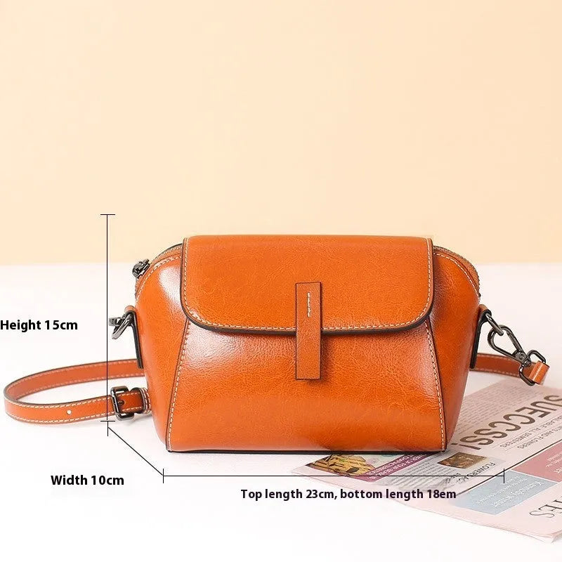 Women's brown oil wax cowhide leather shell shape messenger bag with cross-body strap and interior compartments