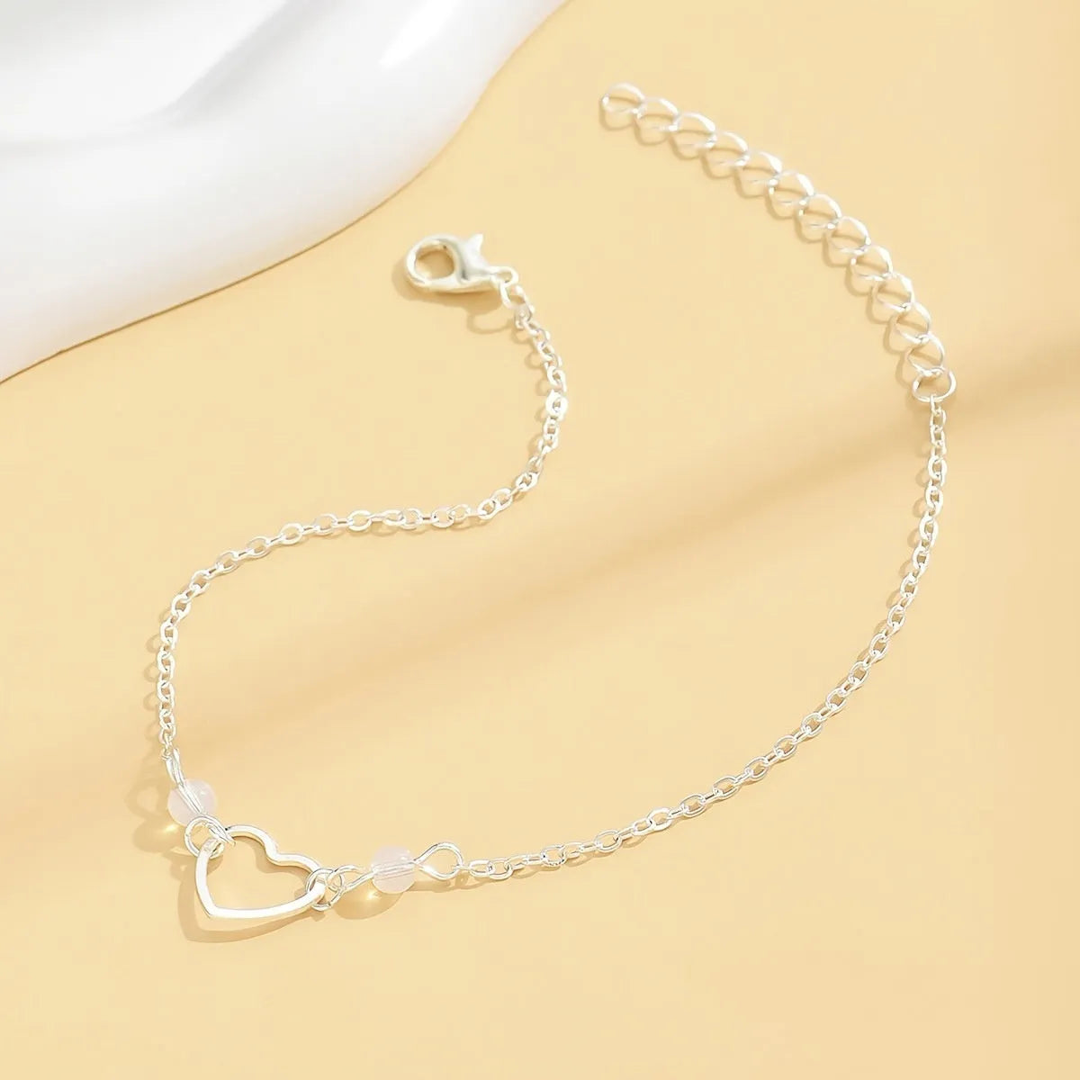 Gold and silver adjustable anklet with heart pendant and geometric chain