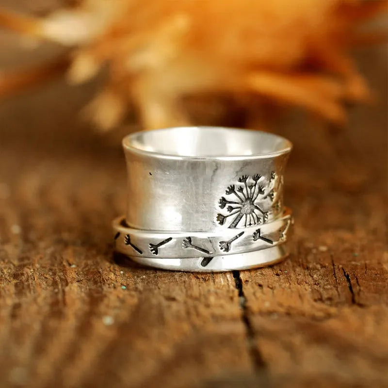 Silver rotatable flower fashion ring showing floral design and adjustable element