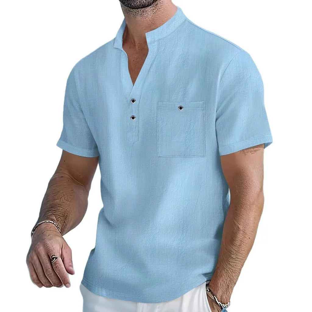 A man wearing a light-coloured linen blend stand collar t-shirt with short sleeves in a loose fit.