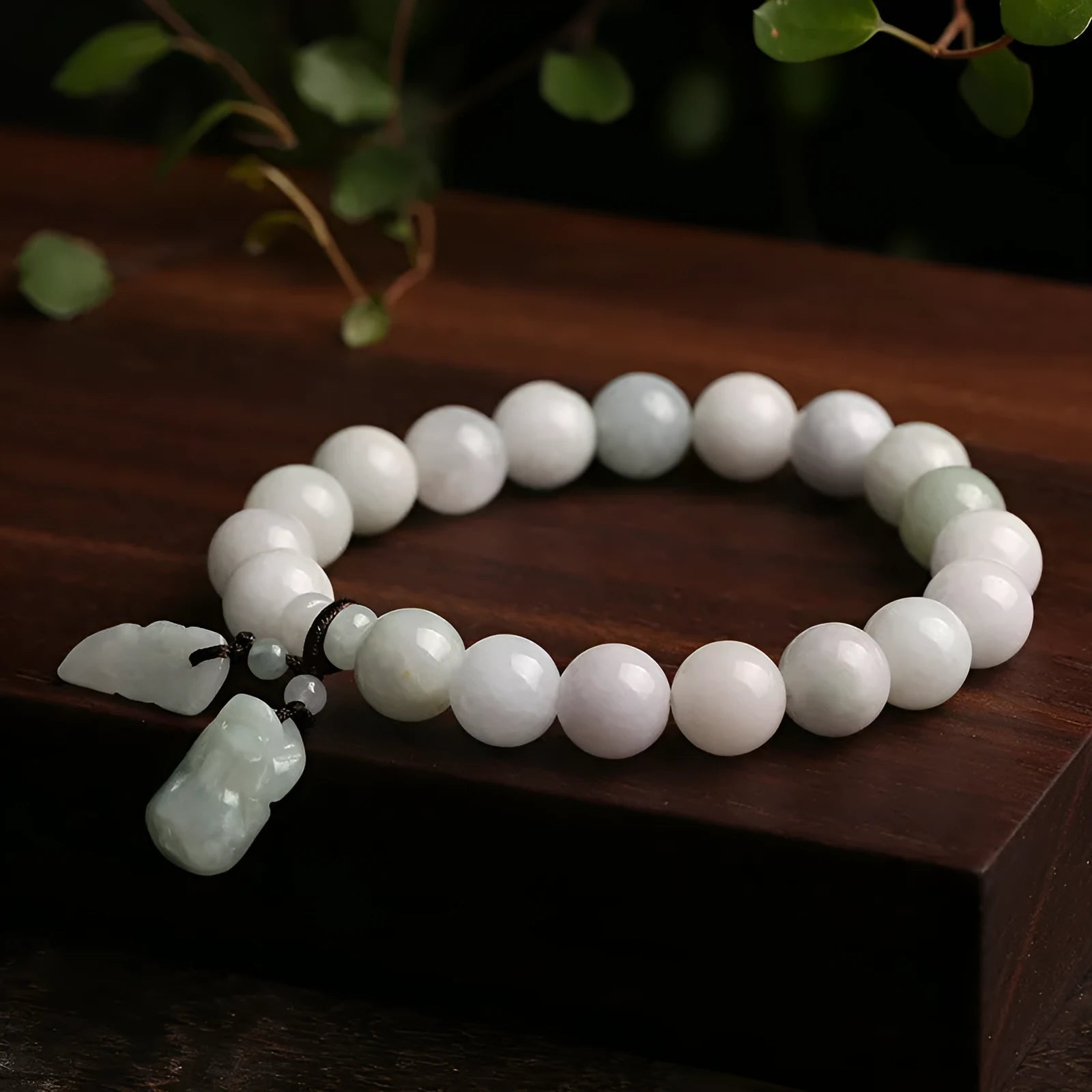 Natural green jade bracelet with a hanging Maitreya Buddha charm on a geometric band.