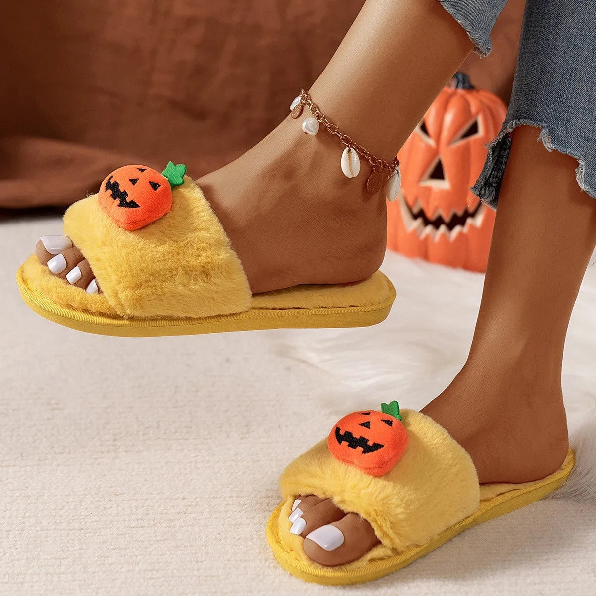 Halloween pumpkin plush slippers with synthetic fur uppers and PVC soles in white and yellow