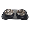 Large black silicone dog bowl sitting inside a stainless steel base, shown on a kitchen floor.