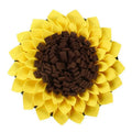 Yellow sunflower-shaped dog snuffle mat with fleece texture and a buckle strap for non-slip use.