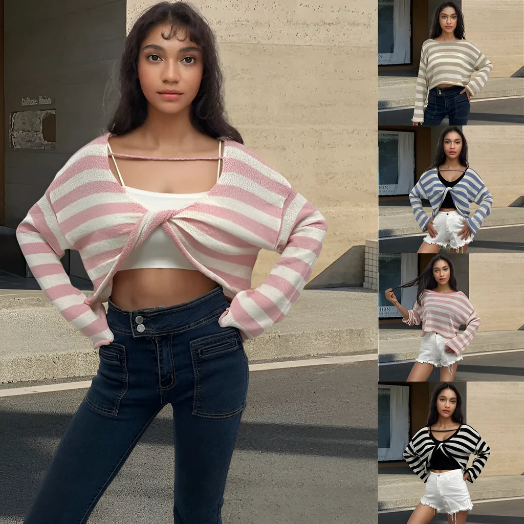 Black and white striped cropped sweater with long sleeves on a woman, showing exposed navel detail.
