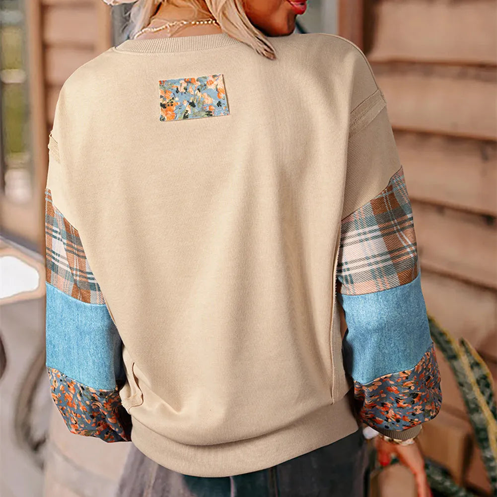 Women's beige and red plaid long-sleeved loose-fit polyester top on a hanger.