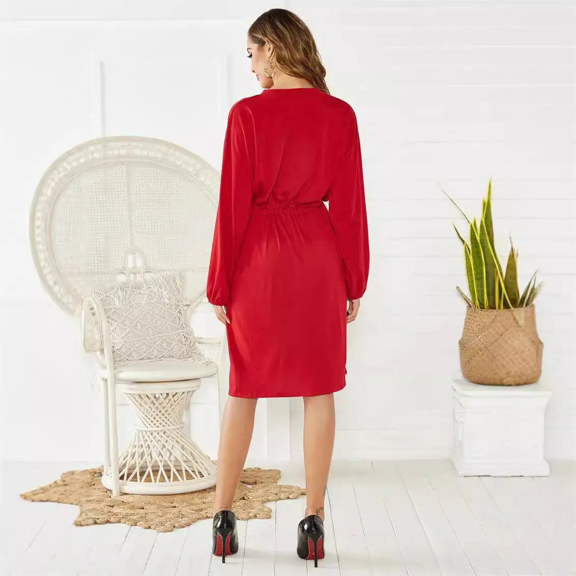Black mid-length A-line dress with elastic waist, cinched belt, and long sleeves with elastic cuffs
