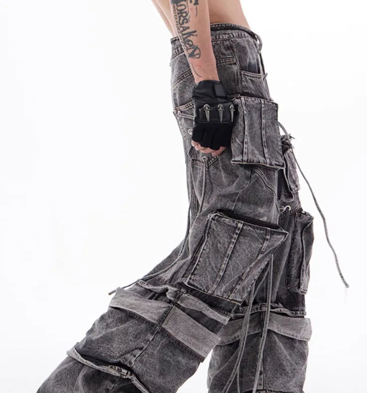Grey distressed denim overalls with rope stitching and mop pant design on male model