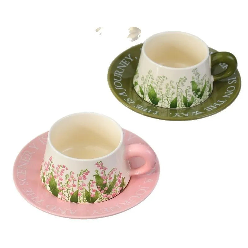 Ceramic coffee cup and saucer set for two with couple's design and stirring spoons