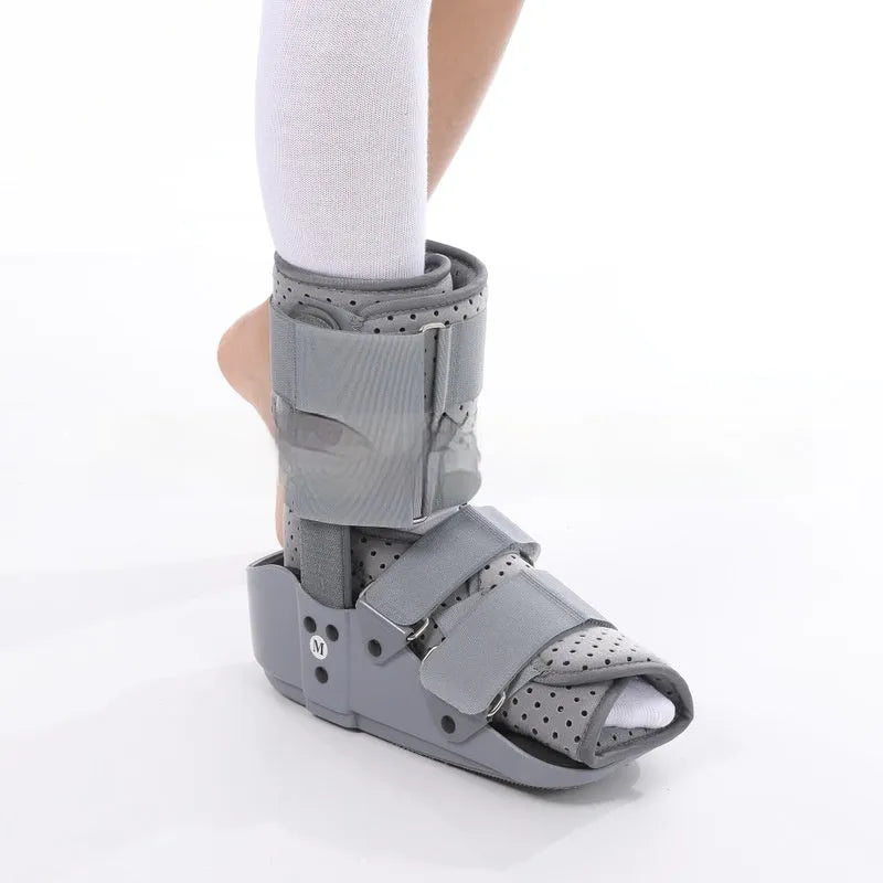 Grey and black Achilles tendon rehabilitation boot with plastic shell, aluminium struts, and adjustable nylon straps.