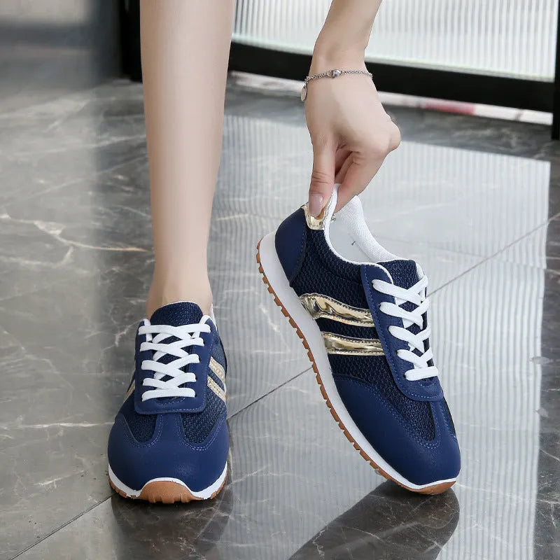 Blue women's casual tennis shoes with cross shoulder straps and white rubber sole