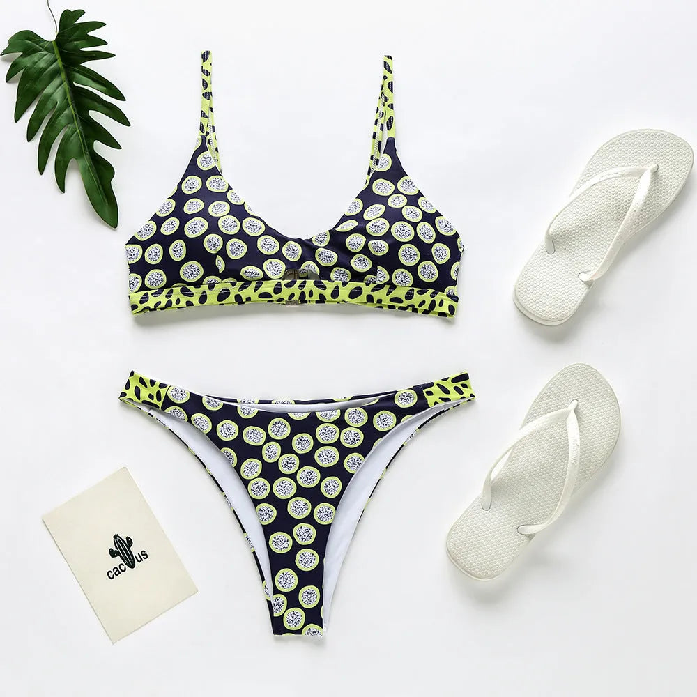 Women's black and white dot polyester bikini set laid flat, showing Asian sizes S, M, L, XL.